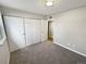 Bedroom features include plush gray carpeting, closet, and neutral paint at 7251 S Xenia Cir # B, Centennial, CO 80112