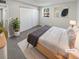 Staged bedroom featuring a light wood bed frame, large closet, and a view out of the window at 7251 S Xenia Cir # B, Centennial, CO 80112