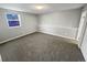 Bedroom showcasing neutral carpet, base trim and a sunlit window at 7251 S Xenia Cir # B, Centennial, CO 80112