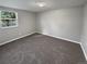 Cozy bedroom with neutral carpet, a window and base trim at 7251 S Xenia Cir # B, Centennial, CO 80112