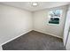 Bright bedroom featuring a large window, neutral paint, and plush gray carpeting at 7251 S Xenia Cir # B, Centennial, CO 80112