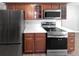 Kitchen featuring stainless steel appliances, light countertops, and cherry wood cabinets at 7251 S Xenia Cir # B, Centennial, CO 80112