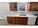 Kitchen featuring white countertops, wood cabinetry, stainless sink, and a window view at 7251 S Xenia Cir # B, Centennial, CO 80112