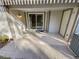 Covered back patio featuring stone pavers, neutral colors, and sliding glass door at 7251 S Xenia Cir # B, Centennial, CO 80112