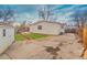 Backyard with wooden path, patio, and small shed at 1156 S Owens Ct, Denver, CO 80232