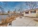 Backyard with a concrete patio, grass, and a fenced in yard at 1156 S Owens Ct, Denver, CO 80232