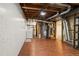 Basement utility area with exposed pipes, a water heater, and a washer, fulfilling essential home functions at 1156 S Owens Ct, Denver, CO 80232