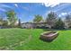 Spacious backyard featuring a fire pit, lush green grass, and ample space for outdoor activities and relaxation at 270 S Chase St, Lakewood, CO 80226