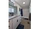Bathroom featuring updated vanity with modern fixtures, granite countertop, and a shower with marble tile surround at 270 S Chase St, Lakewood, CO 80226