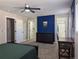 Comfortable carpeted bedroom with a ceiling fan, closet, and attached bathroom entrance at 270 S Chase St, Lakewood, CO 80226