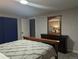Bedroom showcasing a wooden dresser and a bed with a decorative gray comforter at 270 S Chase St, Lakewood, CO 80226