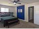 Cozy bedroom features modern furniture, a ceiling fan and a blue accent wall at 270 S Chase St, Lakewood, CO 80226