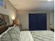 Bedroom featuring a gray bed, two decor wall hangings, and a pair of navy blue closet doors at 270 S Chase St, Lakewood, CO 80226