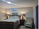 Comfortable bedroom featuring a well-lit area, carpet, and a classic wooden bed frame at 270 S Chase St, Lakewood, CO 80226