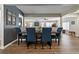 Inviting dining area with wood floors, statement wall, and seating for six at 270 S Chase St, Lakewood, CO 80226