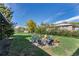 Relaxing backyard area with a stone fire pit surrounded by chairs, ideal for gatherings and outdoor enjoyment at 270 S Chase St, Lakewood, CO 80226