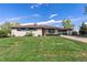 Charming single-story home with a well-manicured lawn and a spacious driveway leading to the garage at 270 S Chase St, Lakewood, CO 80226