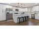 Kitchen features stainless steel appliances, white cabinetry, and island with seating at 270 S Chase St, Lakewood, CO 80226