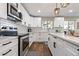 Modern kitchen with stainless steel appliances, white cabinets and subway tile backsplash at 270 S Chase St, Lakewood, CO 80226