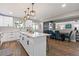 Kitchen features an island with seating, white cabinets, stainless appliances and pendant lighting at 270 S Chase St, Lakewood, CO 80226
