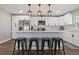 Eat-in kitchen features stainless steel appliances, white cabinetry, and island with seating at 270 S Chase St, Lakewood, CO 80226