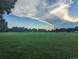 Beautiful green field beneath a cloudy sky with trees on the horizon, great for recreation at 270 S Chase St, Lakewood, CO 80226