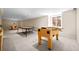 Finished basement game room featuring ping pong, foosball, and air hockey tables at 29 Viking Dr, Cherry Hills Village, CO 80113