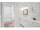 Bright bathroom featuring a white vanity and an adjacent full bathroom with tub at 29 Viking Dr, Cherry Hills Village, CO 80113