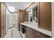 Well-lit bathroom with sleek vanity, tiled floor and walls, and a glass-enclosed shower at 29 Viking Dr, Cherry Hills Village, CO 80113