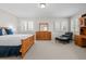 Spacious bedroom with bright windows, shutter blinds, and wood furniture at 29 Viking Dr, Cherry Hills Village, CO 80113