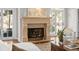 Stone fireplace with ornate iron screen is the focal point of an elegant living room and features French doors to the exterior at 29 Viking Dr, Cherry Hills Village, CO 80113