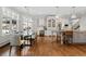 Sunlit kitchen with a breakfast area, island, modern appliances, cabinets, and hardwood floors at 29 Viking Dr, Cherry Hills Village, CO 80113