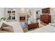 Cozy living room featuring a fireplace, hardwood floors, french doors and stylish furnishings at 29 Viking Dr, Cherry Hills Village, CO 80113
