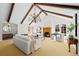 Living room featuring beamed ceilings, a fireplace, and a seating area with white sofas at 29 Viking Dr, Cherry Hills Village, CO 80113