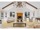 Bright and airy living room featuring high ceilings, a fireplace, and two large windows at 29 Viking Dr, Cherry Hills Village, CO 80113
