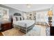 Well-lit bedroom with built-in shelving, large windows, and a comfortable king-sized bed at 29 Viking Dr, Cherry Hills Village, CO 80113