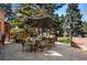 Beautiful outdoor space includes a stone patio with an outdoor dining and grilling area at 29 Viking Dr, Cherry Hills Village, CO 80113