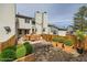 This back yard features a wood fence, a patio with an outdoor dining set, and lots of greenery at 8898 W Plymouth Ave, Littleton, CO 80128