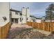 This back yard features a wood fence, a patio with an outdoor dining set, and lots of greenery at 8898 W Plymouth Ave, Littleton, CO 80128