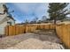 Fenced backyard with stone and gravel landscaping, offering privacy and low-maintenance appeal at 8898 W Plymouth Ave, Littleton, CO 80128