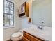 This bathroom features a wood vanity and an oversized window at 8898 W Plymouth Ave, Littleton, CO 80128