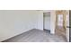 Bright bedroom featuring neutral walls, gray carpet, and closet with sliding doors at 8898 W Plymouth Ave, Littleton, CO 80128