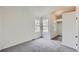 Bright bedroom featuring neutral walls, gray carpet, and large windows for ample natural light at 8898 W Plymouth Ave, Littleton, CO 80128