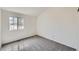 Clean bedroom with a large window letting in natural light and gray carpet at 8898 W Plymouth Ave, Littleton, CO 80128