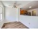 Well-lit dining area with view into kitchen featuring stainless steel appliances and natural wood cabinetry at 8898 W Plymouth Ave, Littleton, CO 80128