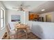 Cozy dining area featuring a ceiling fan, wood floors, and view into the kitchen at 8898 W Plymouth Ave, Littleton, CO 80128