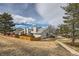 Landscaped townhouse property boasting a well-maintained lawn, charming fences, and neighborhood views at 8898 W Plymouth Ave, Littleton, CO 80128