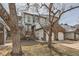 Charming townhouse with attached garage, brick accents, and mature trees at 8898 W Plymouth Ave, Littleton, CO 80128