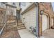 Exterior view of townhouse with stairs leading to front door and side access to garage at 8898 W Plymouth Ave, Littleton, CO 80128