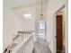 Hallway with carpeted floors, a skylight, and a wooden cabinet at 8898 W Plymouth Ave, Littleton, CO 80128